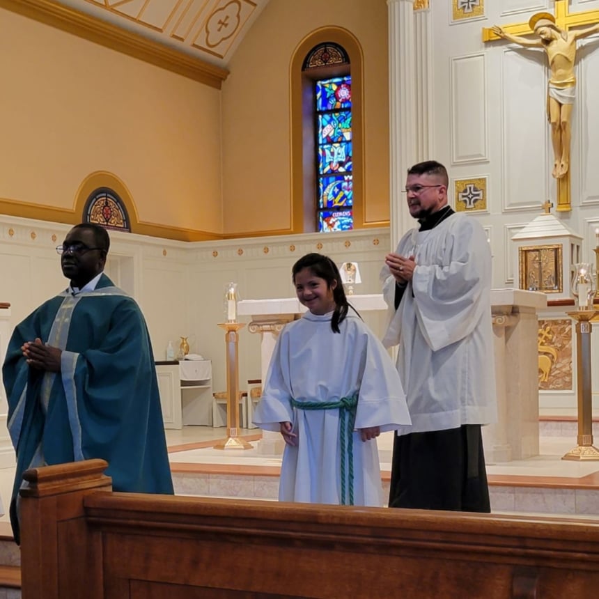 priest and altar servers ready to receive the offertory