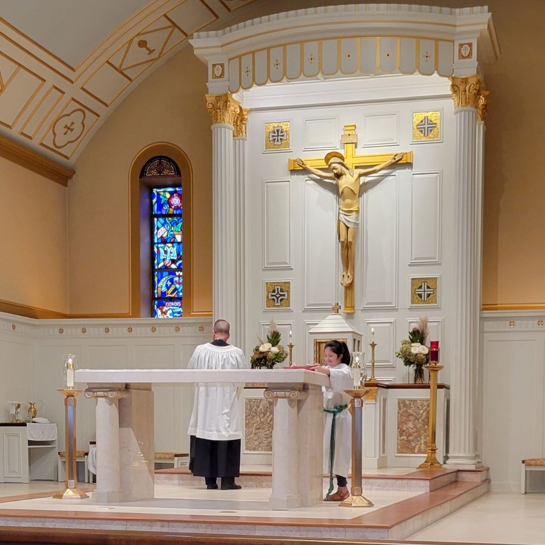 altar servers preparing the altar before Mass