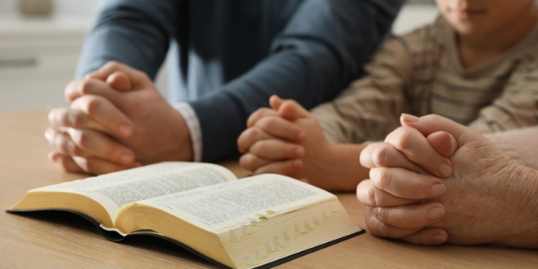 boy-and-his-godparents-praying-together-at-wooden-table-indoors-closeup.jpg_s=1024x1024&w=is&k=20&c=_QZK4INy4uQbKeo8ZeBJ-p7Xj0HuhtBROZDbUzWaTu8=